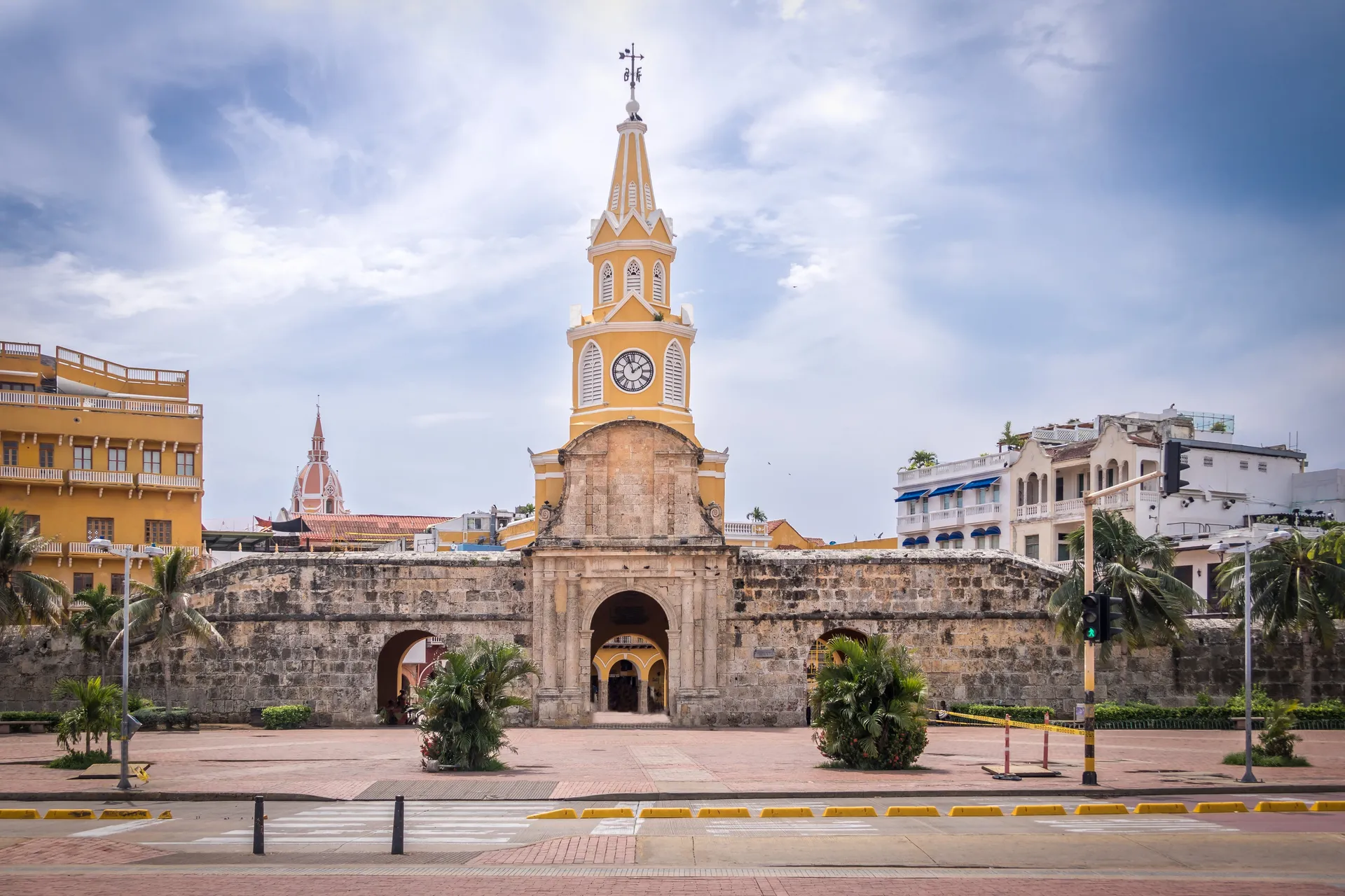 The yellow Torre del Reloj clock tower gate at the entrance to Cartagena's walled old city
