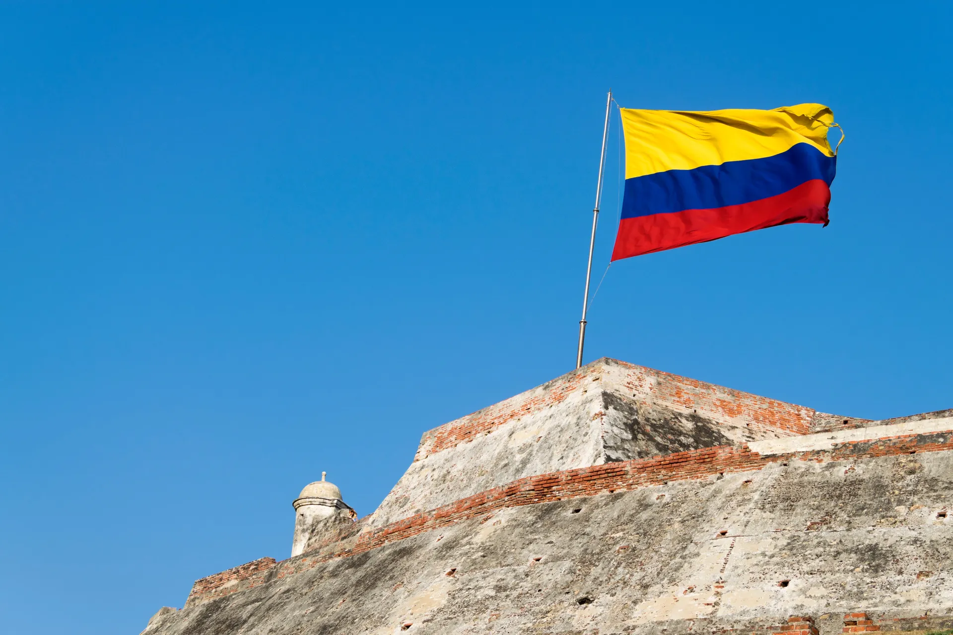 The Colombian flag flying above the walls of the Castillo San Felipe de Barajas in Cartagena