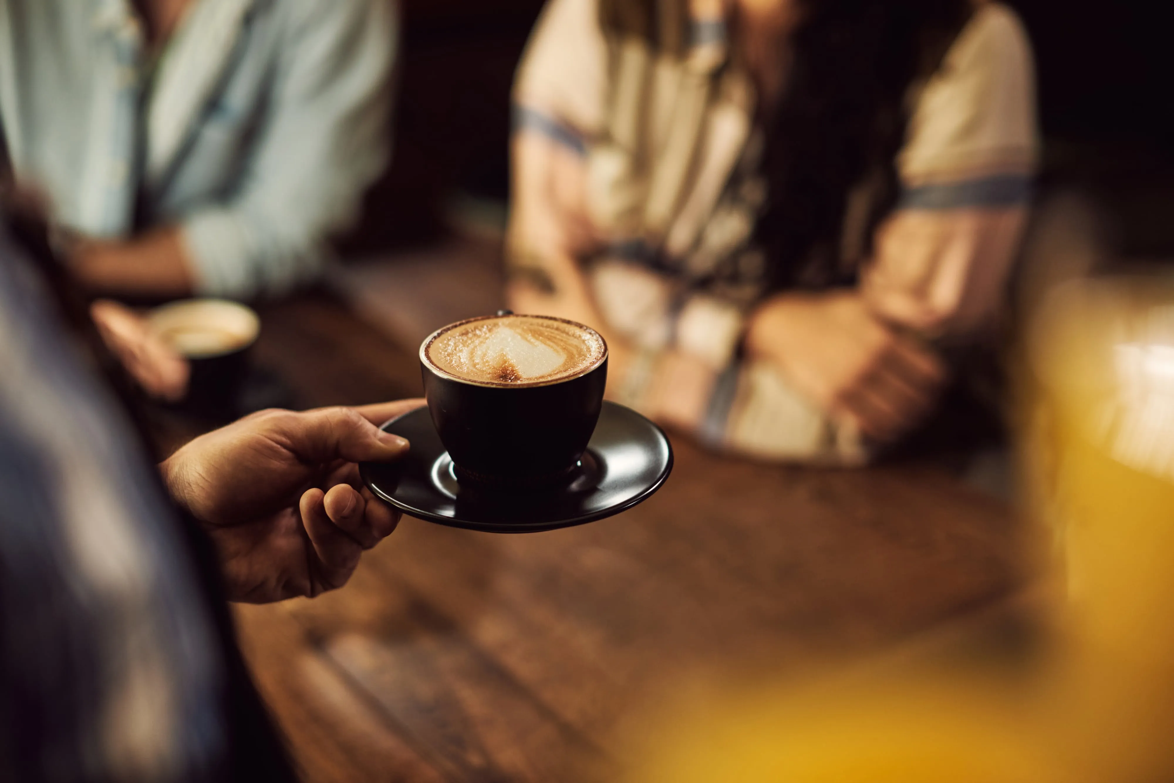 A cup of Colombian coffee on a wooden table in a café in the coffee region
